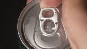 Hands close-up opening aluminum can with soda inside. Water drop droplets on metal jar. Food Beverage. Male hand opening shaking metal can of beer on black gradient background in slow motion. - Powered by Shutterstock - Get 15% off with code: PIKWIZARD15