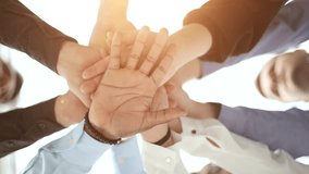 young volunteers putting their hands on top of each other like a real team while standing in charitable organization office - Powered by Shutterstock - Get 15% off with code: PIKWIZARD15