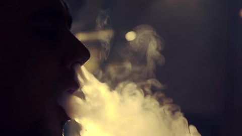 Young man smoking hookah in a bar
