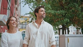 Tourist couple walking city street closeup. Romantic family hugging outdoor contemplating architecture together. Happy man woman pointing fingers admiring mediterranean town square at vacation  - Powered by Shutterstock - Get 15% off with code: PIKWIZARD15