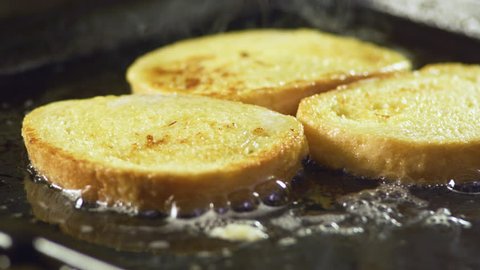 Preparing french toast for breakfast, on electric grill, close up