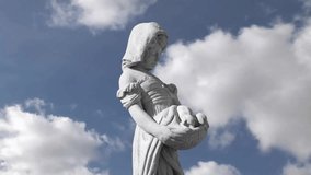 Animation of gray sculpture of woman over blue sky and clouds. Abstract background, art and statuary concept, digitally generated video.