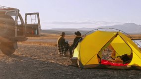 Group of Friends reparing coffee near travel suv. People enjoying a day camping. Autumn vacations and relationship concept. Picnic near car on sunset outside. Domestic travel concept. - Powered by Shutterstock - Get 15% off with code: PIKWIZARD15