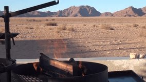 HD high quality video scenic view from a veranda with fire ready for barbecue in famous endless sand sea area of Sossusvlei Namib Desert red sand dunes on sunny day in Namib-Naulkuft Park in Namibia