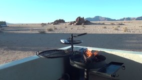 HD high quality video scenic view from a veranda with fire ready for barbecue in famous endless sand sea area of Sossusvlei Namib Desert red sand dunes on sunny day in Namib-Naulkuft Park in Namibia