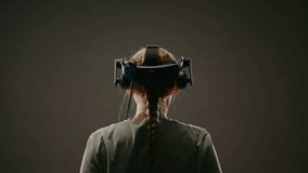 The woman wearing VR headset plays video game. The woman moves activity immersive experience herself in game.Screen with blur background.Concept fun active leisure in virtual reality, high technology