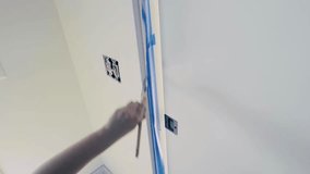 Video of the man who paints the door frame white with a brush and knows his job