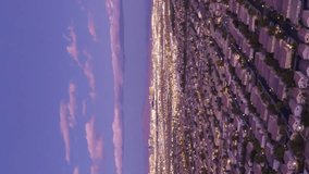 Las Vegas Skyline in Evening Twilight. Nevada, USA. Aerial Hyper Lapse, Time Lapse. Drone Flies Sideways. Vertical Video