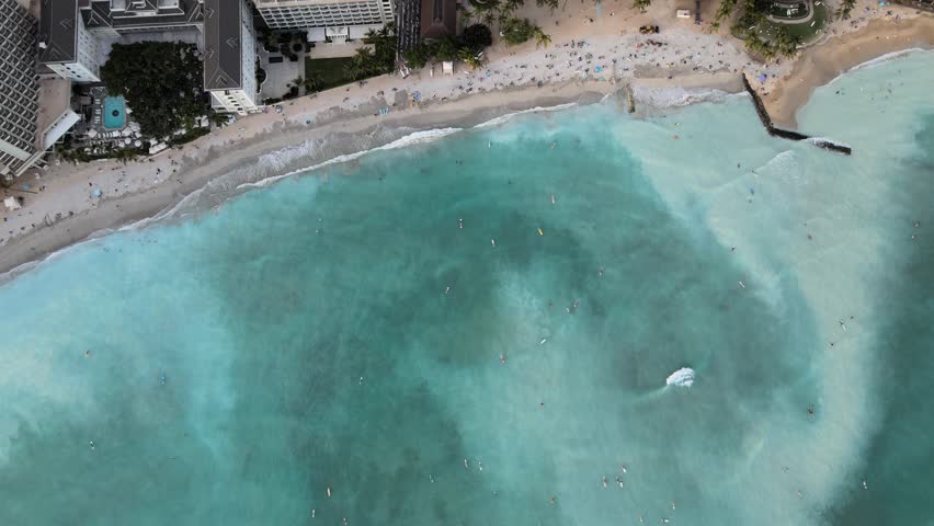 An aerial drone footage of Waikiki beach during daytime in Hawaii