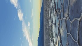 Badwater Basin at Sunset. Salt Crust and Clouds Reflection. Death Valley National Park. California, USA. Moving Panning Time Lapse. Vertical Video - Powered by Shutterstock - Get 15% off with code: PIKWIZARD15