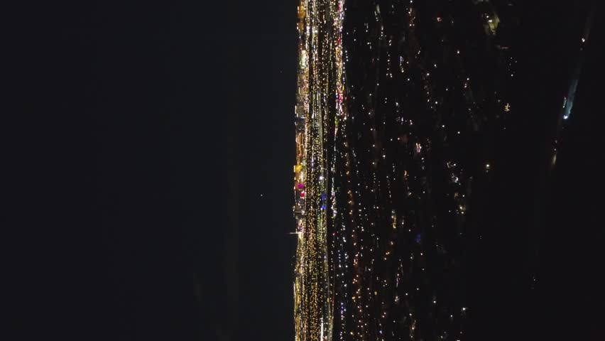 Las Vegas Cityscape at Night. Nevada, USA. Aerial View. Drone Flies Forward. Vertical Video
