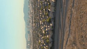Las Vegas in Sunny Day. Downtown and Residential Neighborhood. Nevada, USA. Aerial View. Drone Flies Forward, Tilt Up. Reveal Shot. Vertical Video