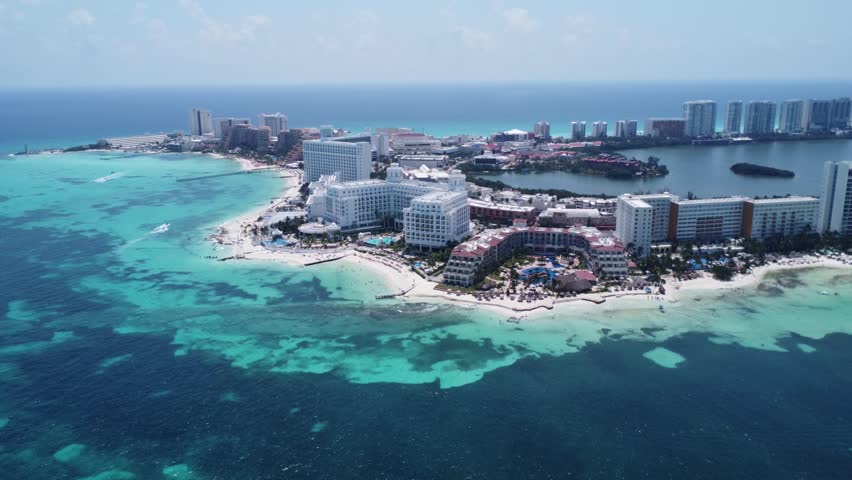 Cancun, Mexico. Captivating aerial showcases the exquisite Hotel Riu Palace Las Americas nestled within the hotel zone. All-inclusive resort embodies the epitome of a luxurious vacation experience. Royalty-Free Stock Footage #3400647217