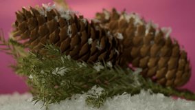 Christmas tree cone with a blue new year tree in front of a beautiful flashing color background. Slow motion, 8K downscale, 4K.