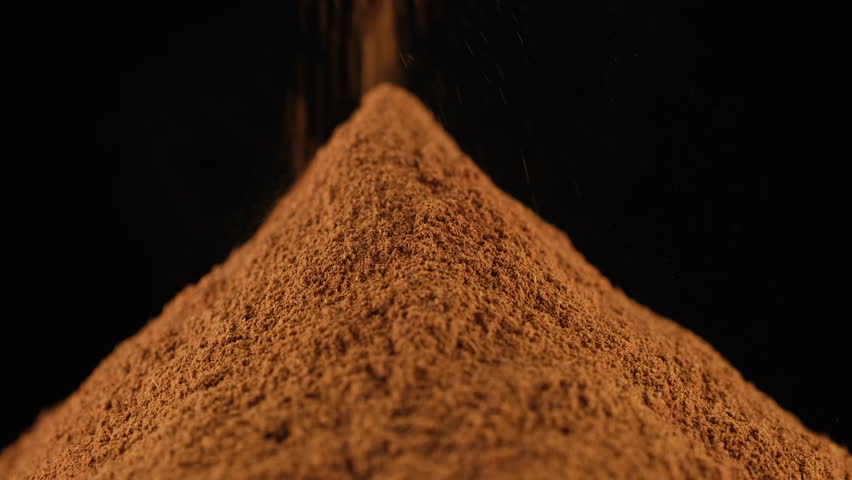 Zoom frame heap cinnamon powder isolated on black background