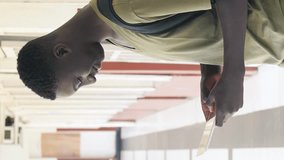 African teenager in the high school hallway. Vertical Video - Powered by Shutterstock - Get 15% off with code: PIKWIZARD15