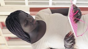 African teenager in the high school hallway. Vertical Video - Powered by Shutterstock - Get 15% off with code: PIKWIZARD15