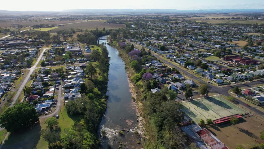 Tennis Academy And Houses On The Banks Of Richmond River In Casino Town, New South Wales, Australia. aerial pullback shot