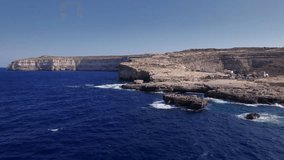 Aerial panoramic drone footage of Inland Sea in Dwejra Bay with Fungus Rock, Azure Window, underwater cave on the Maltese Island of Gozo, Malta, Mediterranean, Europe