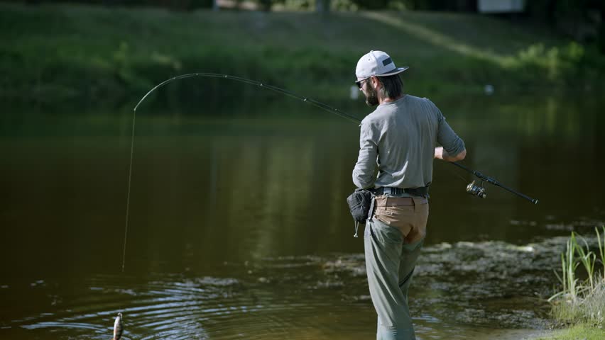 Fisherman With Rod Catching Fish River. Fishing Pike Perch On Spinning Reel. Fisher Pulling Rod Fishing. Angler Catch Fishing Trophy. Fisherman Carbon Rod ,Reel Fishing Perch Or Pike Sport Recreation Royalty-Free Stock Footage #3400756401