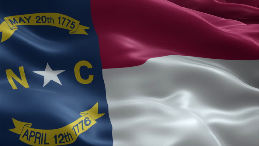 North Carolina flag video waving in wind. Realistic flag background. Close up view, perfect loop, 4K footage