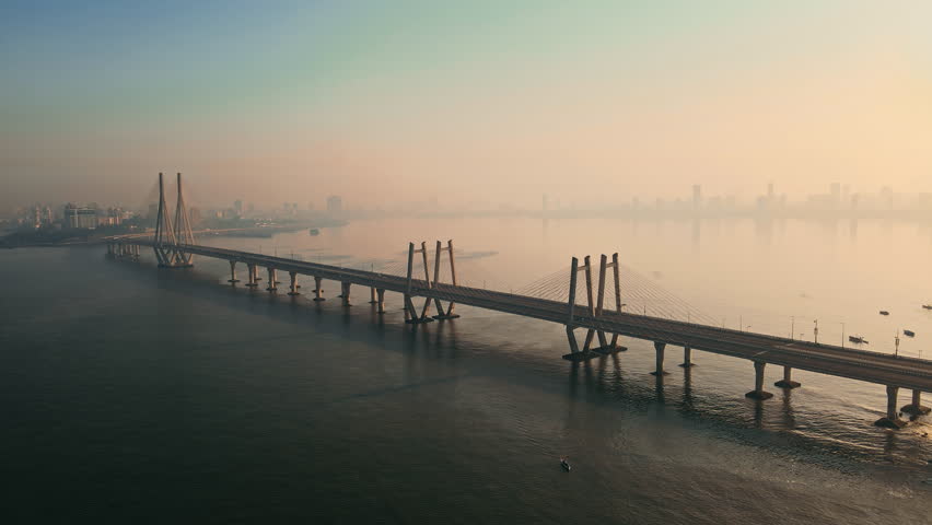 Cinematic Aerial view of vehicles Passing over Bandra Worli Sea Link in Mumbai, India. Weather in Mumbai, Morning skyline Mumbai. Developing India concept. Longest Bridge in India.