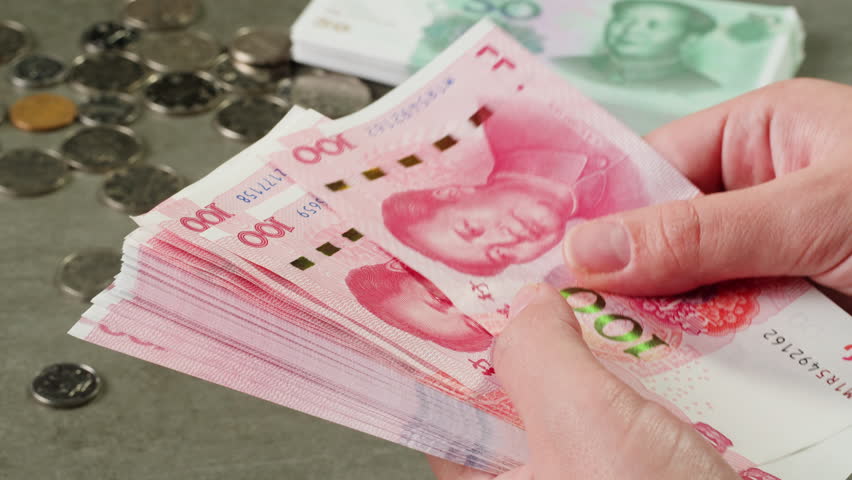 Detailed close up of 100 Yuan, the Chinese currency,CNY. A big wad of money 100 Renminbi the highest denomination of china's money. Footage of chinese banknotes. Counting money, finance