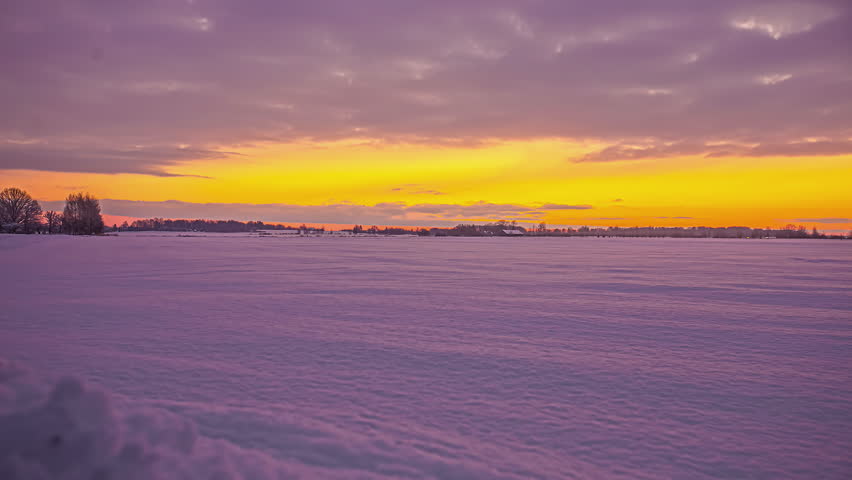 Peaceful sunrise in frozen winter wonderland time lapse with snow in rural countryside Royalty-Free Stock Footage #3400805057