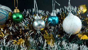 Christmas decoration, colorful hanging ornaments, blue green white gold colors, new year decorated, shiny lights, cinematic close-up tilt up 4K video