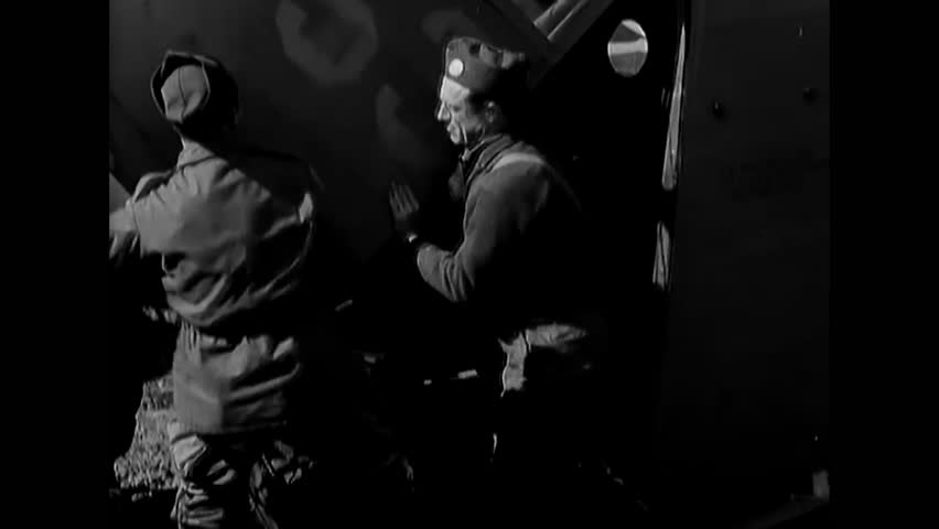 BELGIUM - 1944 - 82nd Airborne Division paratroopers load a jeep onto a glider on an airstrip in Belgium.
