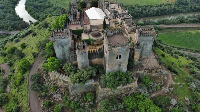 Majestic aerial view of Almodovar Castle with Guadalquivir River behind