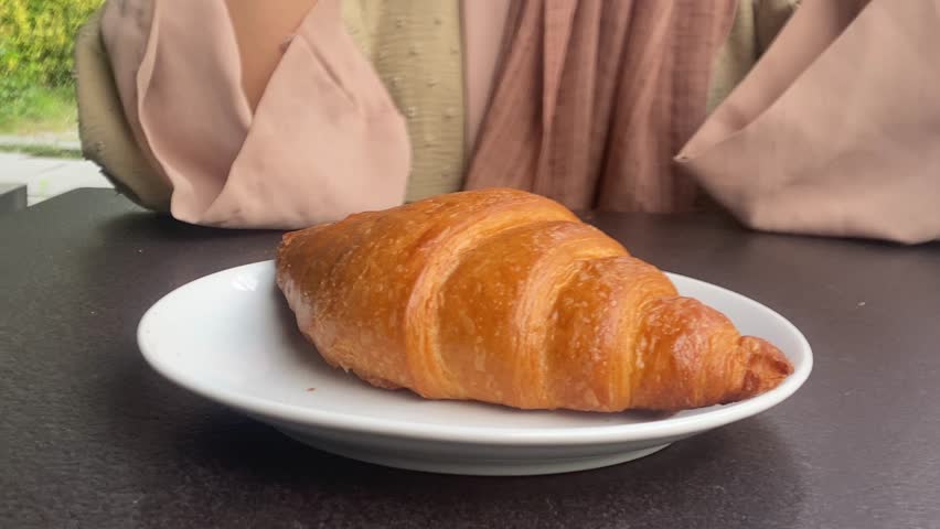 women hand pick fresh baked croissant