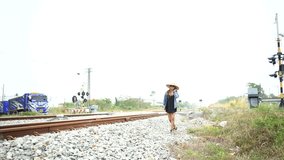 Young business woman working at the computer. strolling along the train tracks and then a train passed. work from home and  travel concept  