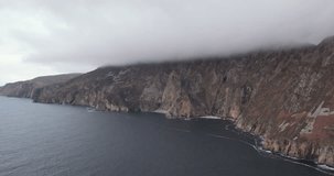 Spectacular 4K aerial video of flying above scenic Slieve League cliffs in Northern Atlantic at evening time, Carrick, Donegal, Ireland