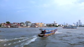 Long tail boat running on the Chao Phraya River, tourist attractions in Thailand, Beautiful river view in Thailand, Tourists traveling by boat, River Trips of the Chao Phraya River.