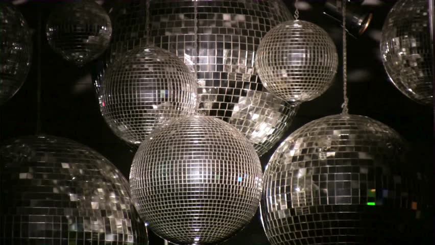 Disco party balls on ceiling. Background of several disco balls. Disco balls in a nightclub room. Party concept. Close up sparkly silver disco balls. Mirror ball Illumination dark. Royalty-Free Stock Footage #3401149809
