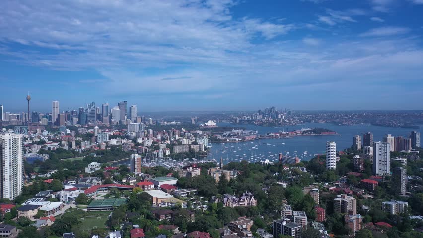 Aerial panorama of Sydney Skyline from Eastern Suburbs featuring Harbor Bridge Opera House, Darling Point and Rushcutters Bay with sunny summer weather and blue sky.