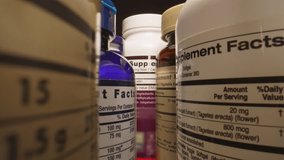 Plastic Jars of Tablets, Fish oil, Omega 3 or D-3 pills. The Camera Moves Through Many Containers of Dietary Supplements Pills for a Healthy Lifestyle - The Basis of a Healthy Diet. - Powered by Shutterstock - Get 15% off with code: PIKWIZARD15