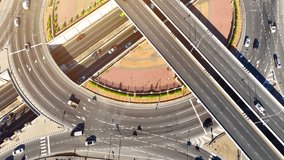 A seamlessly integrated interchange, where the tunnel discreetly navigates beneath the roundabout, epitomizing urban design that optimizes traffic and aesthetics. Car and city concept. Drone view.
