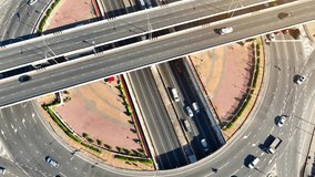 A drone's-eye perspective reveals the timelapse interchange roundabout with tunnel as an ever-changing, kaleidoscopic masterpiece of modern engineering, a time-lapsed canvas in motion. Time lapse.
