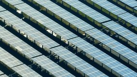 Solar power plants, nature's magic, These gleaming arrays of panels dance with sunlight, generating electricity while preserving our planet's beauty. Aerial view drone.
