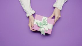 Beauty of giving and receiving gifts, presents between man woman, violet top view. Couple celebrations, anniversaries, or expressions of affection. Happy birthday, Mother's day. - Powered by Shutterstock - Get 15% off with code: PIKWIZARD15