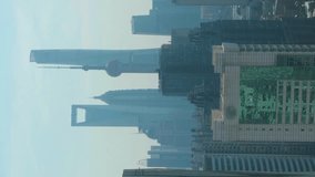 Shanghai City. Urban Lujiazui Skyline at Sunny Day. China. Aerial View. Drone Flies Forward. Vertical Video