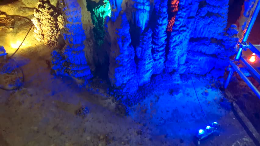 Venetsa Cave near Vidin, Bulgaria. Beautiful colorful and illuminated cave full with semiprecious onyx stones. Flowstones, stalactites and stalagmites lighted in different vivid colours. Royalty-Free Stock Footage #3401407485