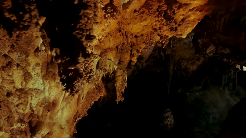 Venetsa Cave near Vidin, Bulgaria. Beautiful colorful and illuminated cave full with semiprecious onyx stones. Flowstones, stalactites and stalagmites lighted in different vivid colours. Royalty-Free Stock Footage #3401407677