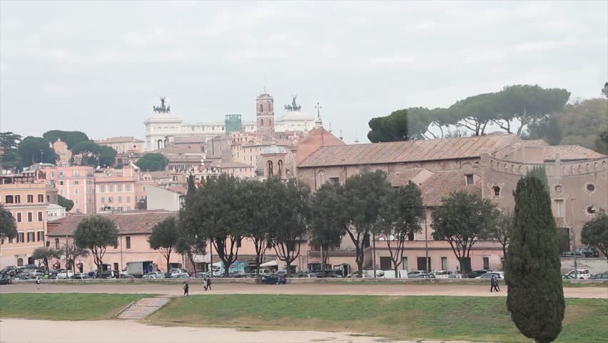 rome italy building with trees and traffic passing in fron