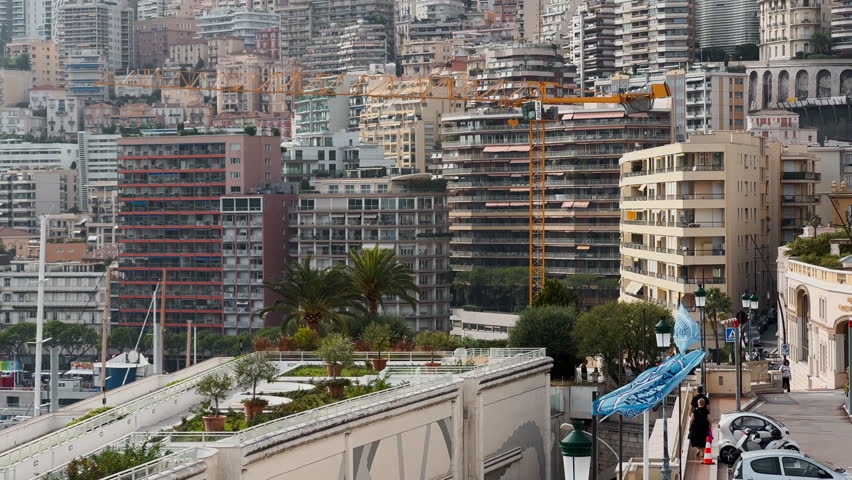 Residential complex of Monaco at sunset, buildings of different height against mountains, skyscrapers, clouds over city