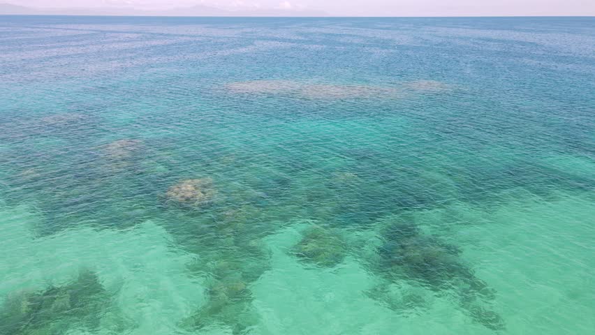 Flying low over a healthy coral reef system in The Great Barrier Reef Marine Park. Drone view