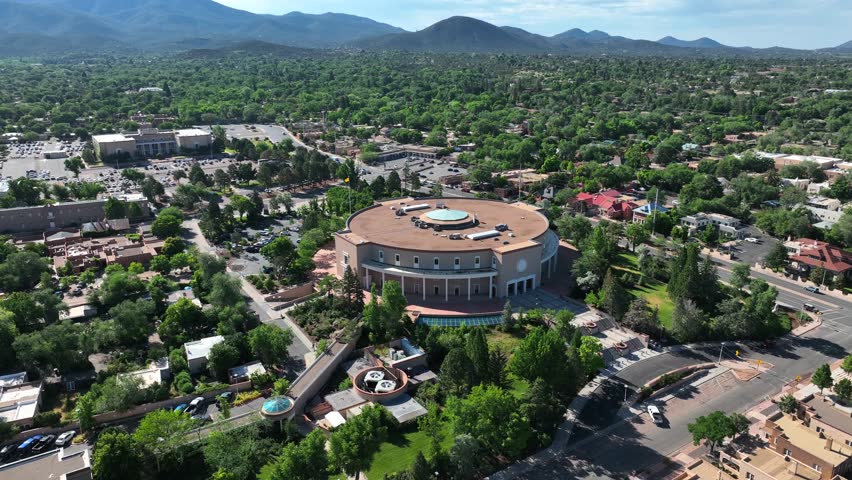 New Mexico capitol building in downtown Santa Fe during summer. Aerial orbit of round government building.