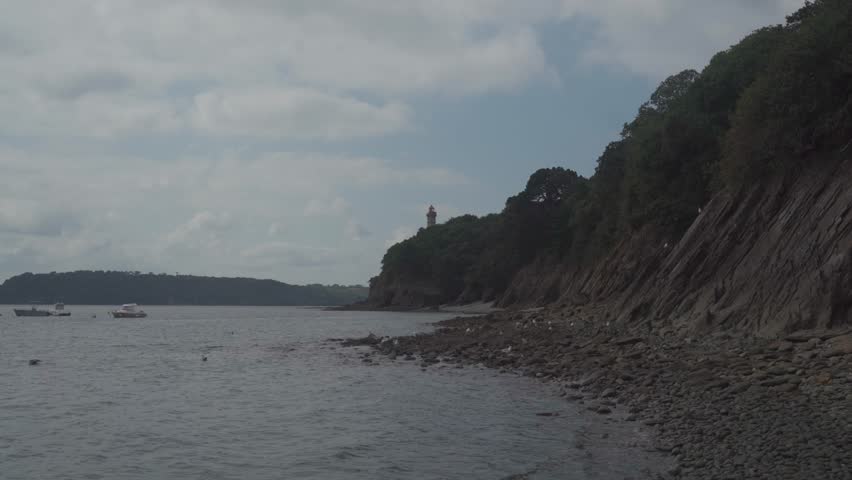 Phare Du Portzic lighthouse and the rocky shore of the ocean in the French city of Brest. View of the Phare du petit minou in Plouzane, Brittany, France. Portic Lighthouse.